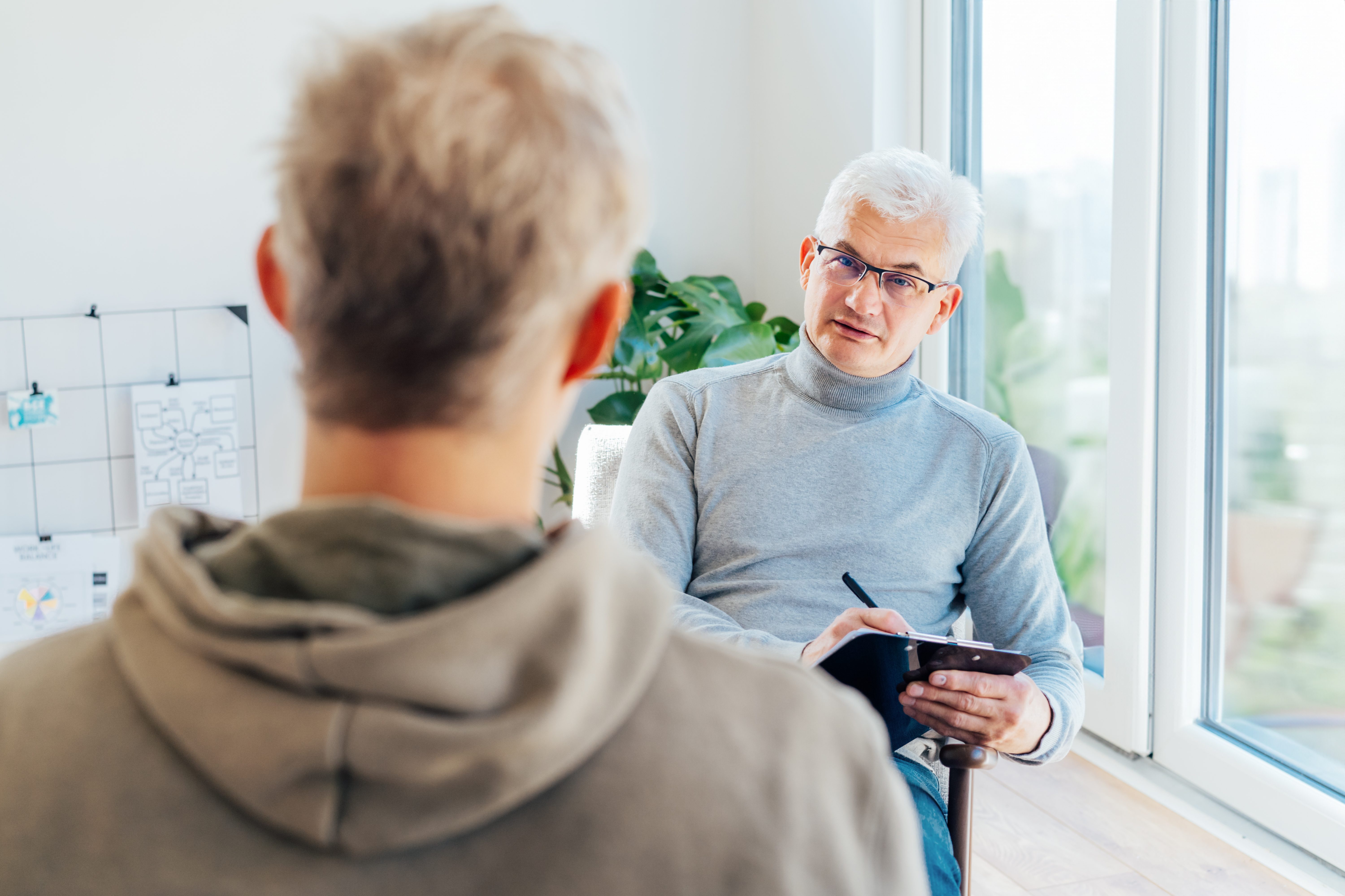 Professional psychotherapy. Male psychologist having session with patient at mental health clinic